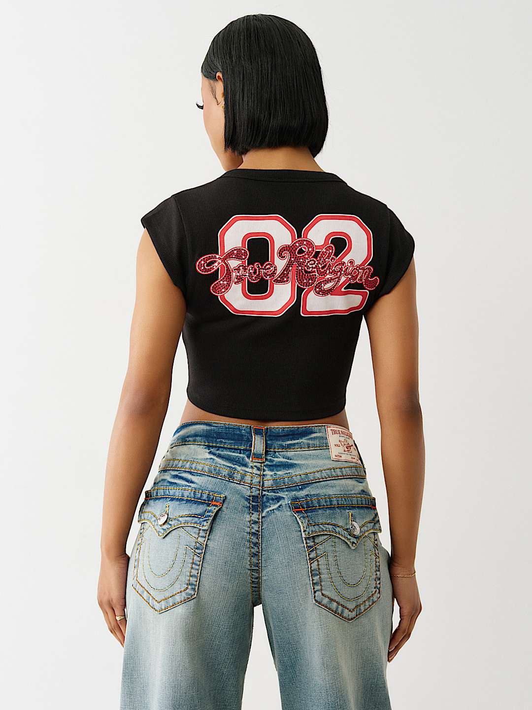 TRUE RELIGION ONLINE EXCLUSIVE CRYSTAL LOGO NOTCH BABY TEE