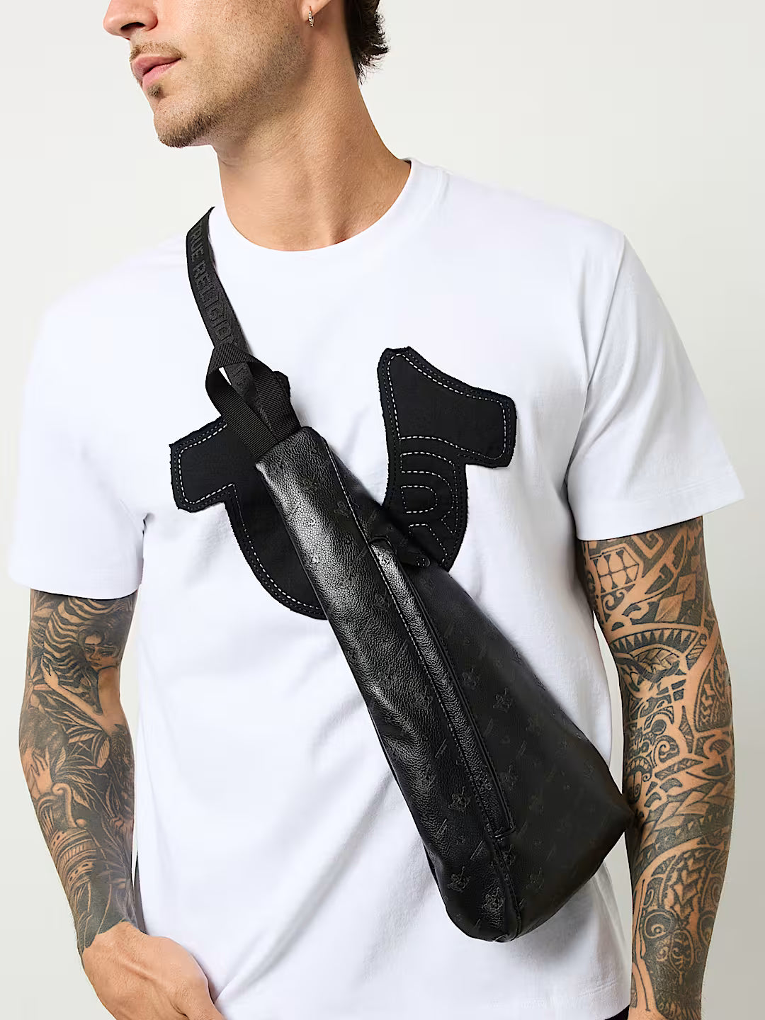 TRUE RELIGION PEBBLED MONOGRAM SLING BAG