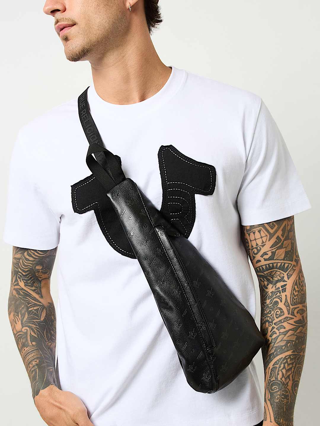 TRUE RELIGION PEBBLED MONOGRAM SLING BAG